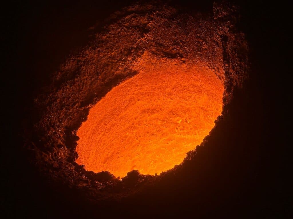Molten metal glowing inside an induction furnace crucible relined with Lukorma neutral ramming mass