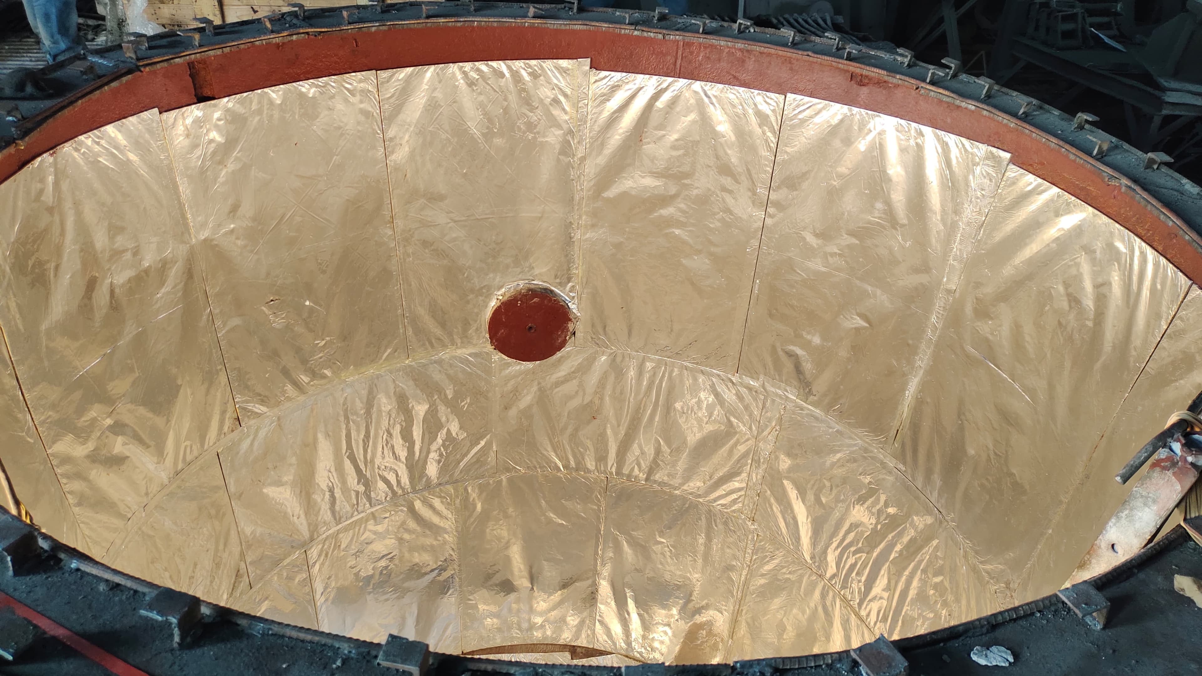 Gold micro-porous insulation lining the inside of a furnace vessel