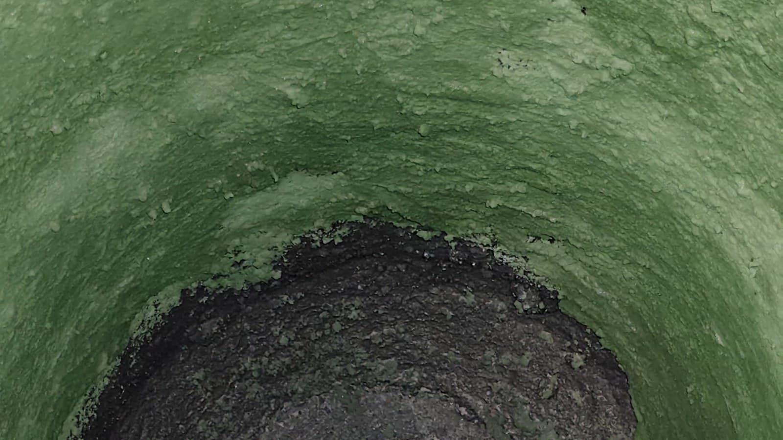 Green chrome-based Alu Pak 73 Cr patching material lining the inside of an induction furnace