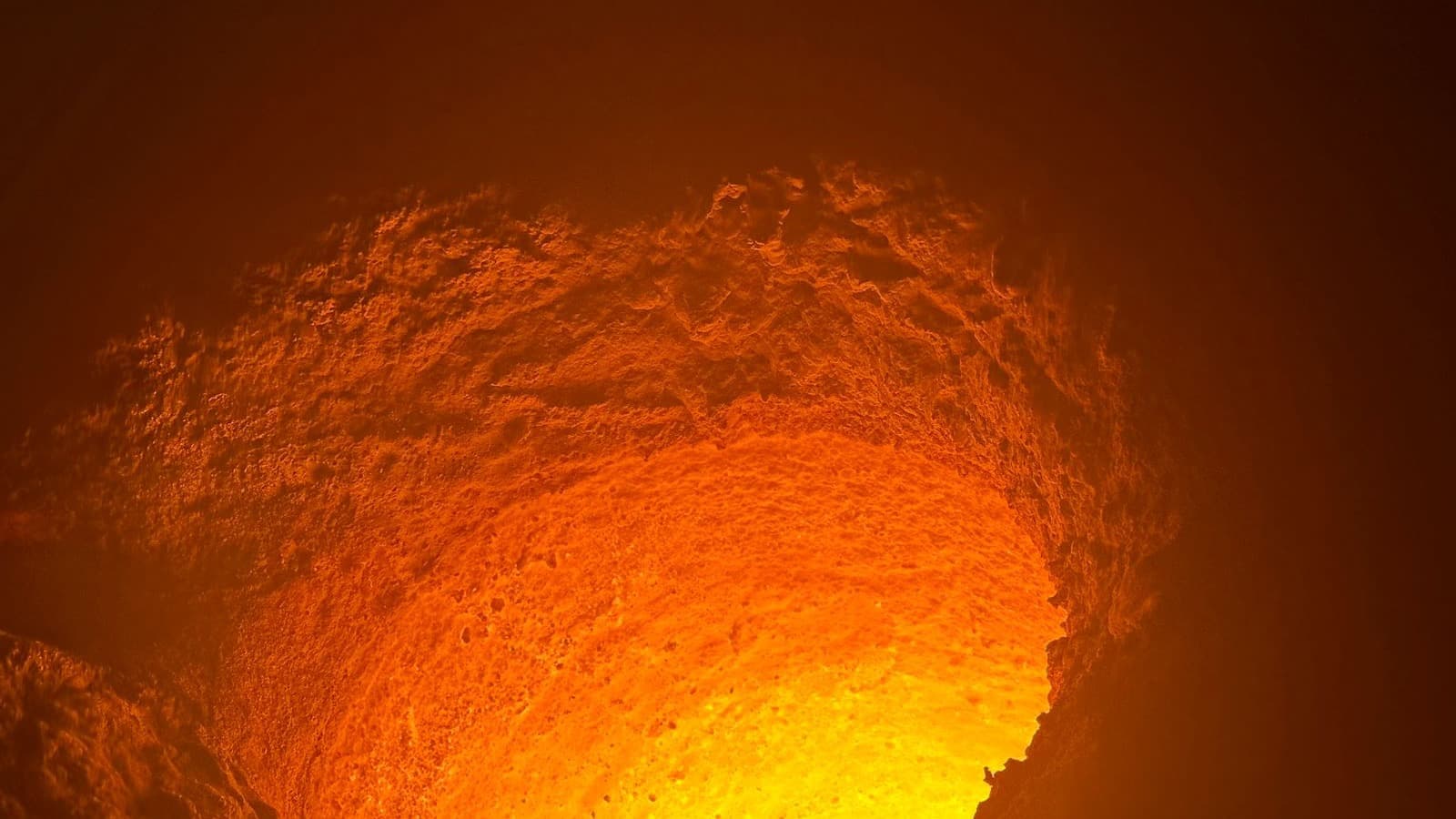 Glowing interior of a coreless induction furnace lined with DFP India neutral ramming mass