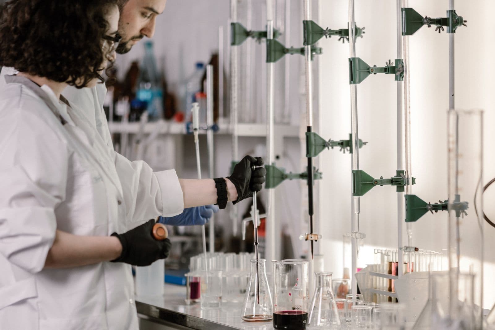 Technicians running titration analysis in a quality-control laboratory